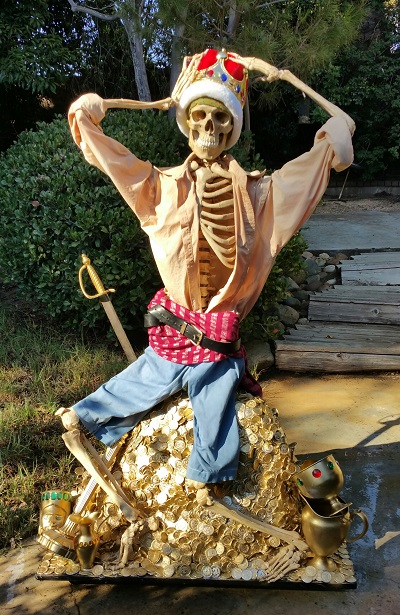 pirate skeletonsitting on gold pile display
